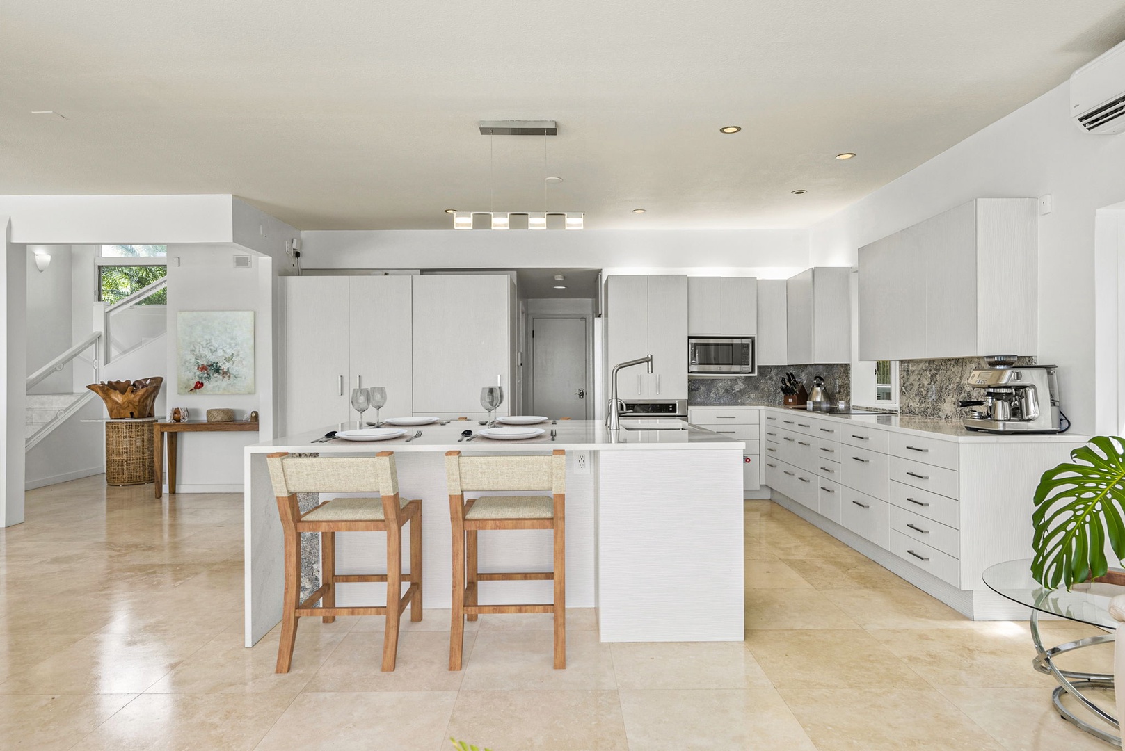 Honolulu Vacation Rentals, Paradise Beach Estate - Prep, serve, and socialize with ease at this oversized kitchen island featuring seating and views into the bright great room.