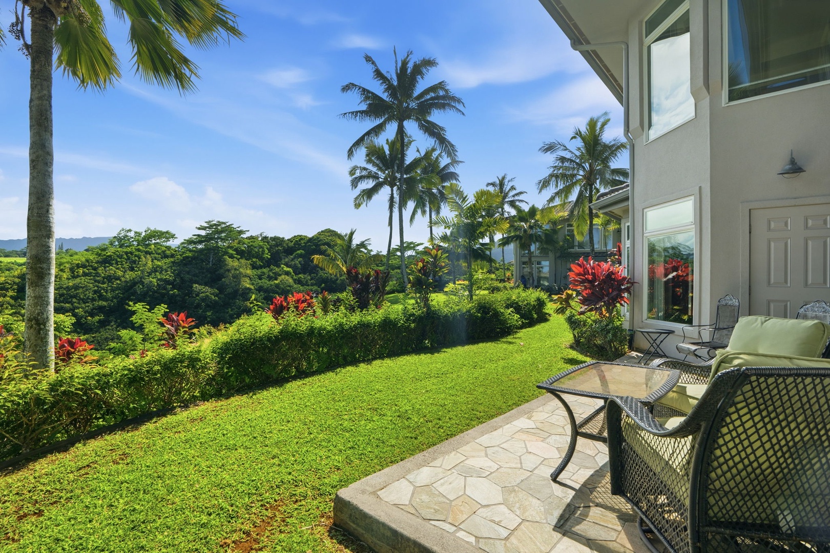 Princeville Vacation Rentals, Kaiulani #8 - Drag a chair to the edge of the stone patio and watch clouds cross the hills.