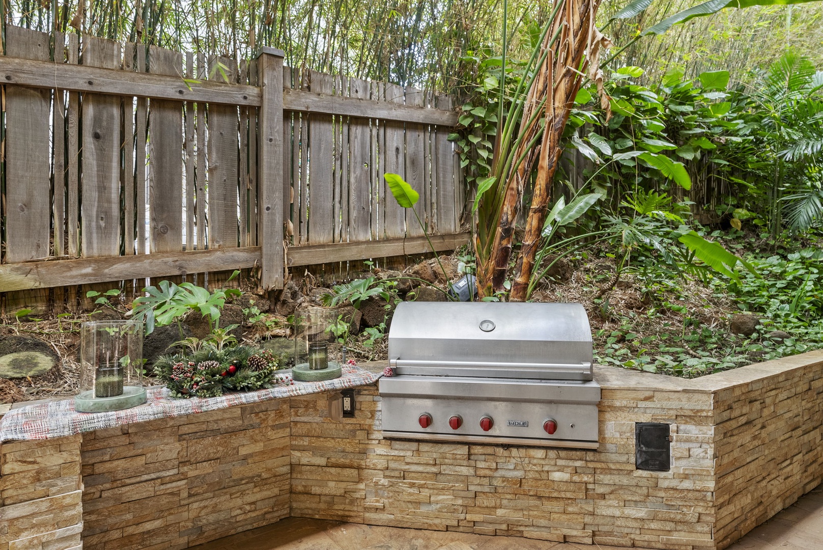 Honolulu Vacation Rentals, Pili Pono - Built-in barbecue station with stone finishes and tropical plants.