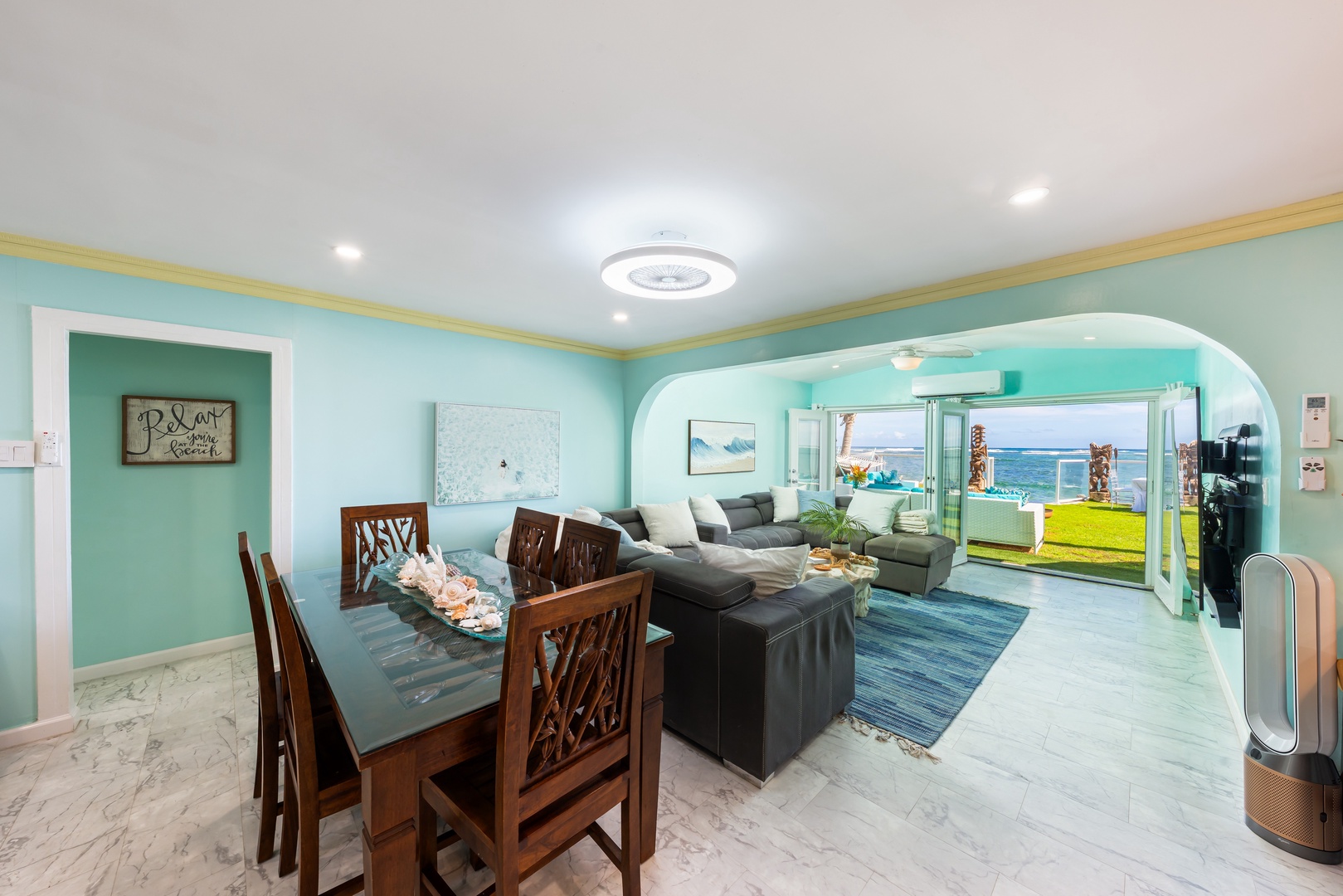 Hauula Vacation Rentals, Private Beach Paradise - Bright open living and dining space with calming coastal tones and ocean views beyond.