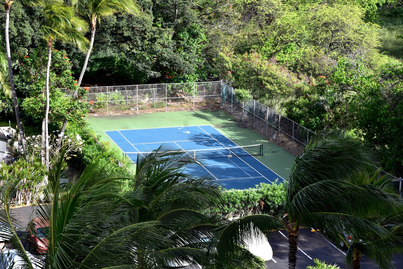 Waianae Vacation Rentals, Makaha - Hawaiian Princess - 305 - An aerial view of the tennis courts surrounded by lush greenery.