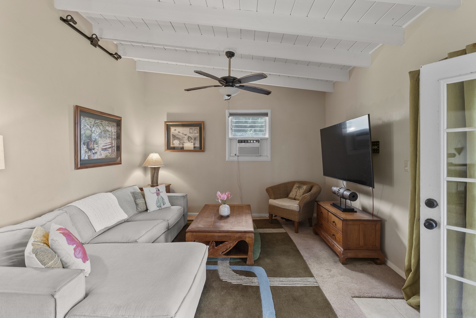 Haleiwa Vacation Rentals, North Shore Beachfront Retreat - Comfortable living room with cozy seating and entertainment setup.