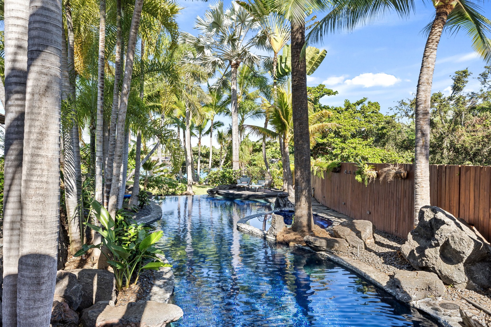 Kailua-Kona Vacation Rentals, Hahalua Bay Villa - Dive into your private tropical oasis where swaying palms frame crystal-blue waters and natural rock features create the perfect escape.