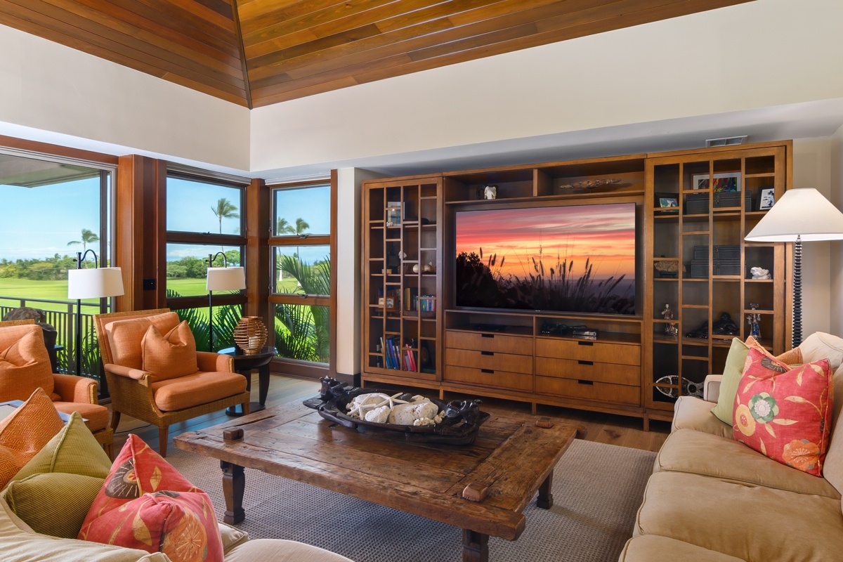 Kailua Kona Vacation Rentals, Fairways Villa 120A - Relax in your luxurious living room featuring a stunning entertainment center and panoramic golf course views through floor-to-ceiling windows.