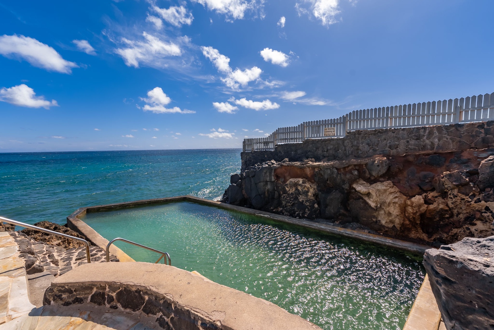 Honolulu Vacation Rentals, Black Point Ocean Villa - Black Point Pool carved into volcanic rocks offers refreshing swims with direct sea access and stunning coastal views.