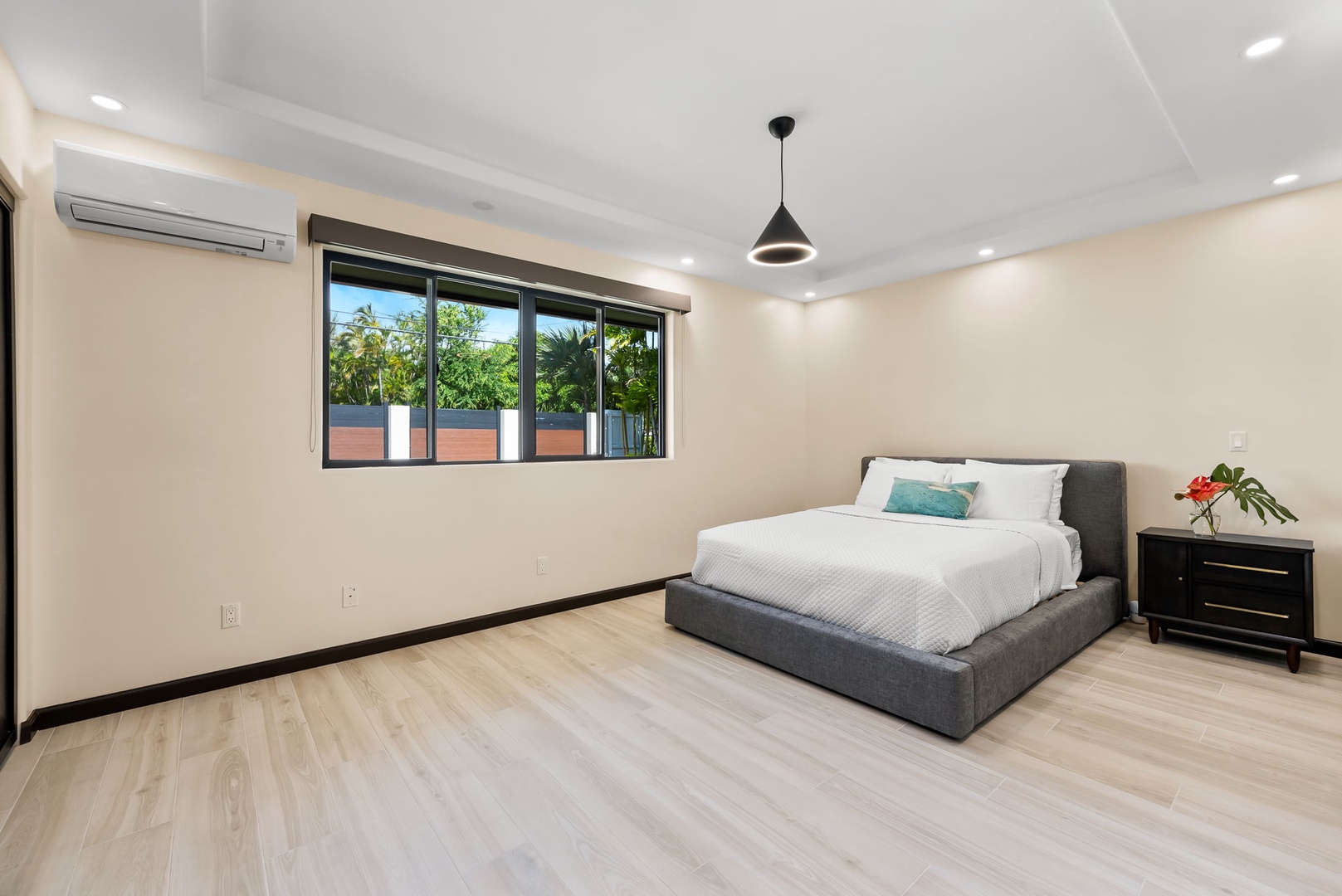 Honolulu Vacation Rentals, Kahala Zen - Minimalist primary bedroom with a king-size bed and soft natural lighting.