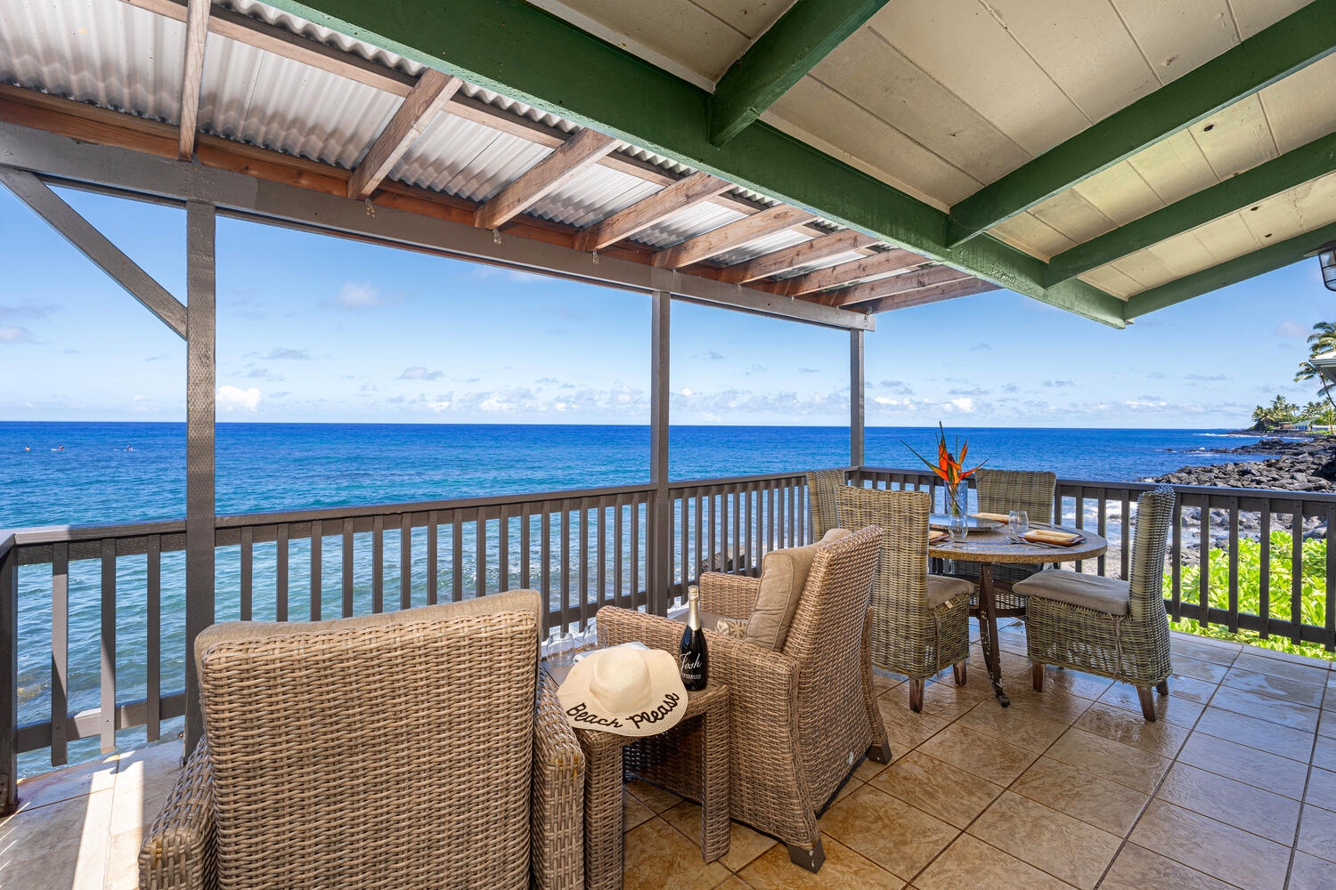 Kailua Kona Vacation Rentals, The Cottage - Lanai stretches along the home, offering multiple spaces to dine, lounge, and watch the waves.