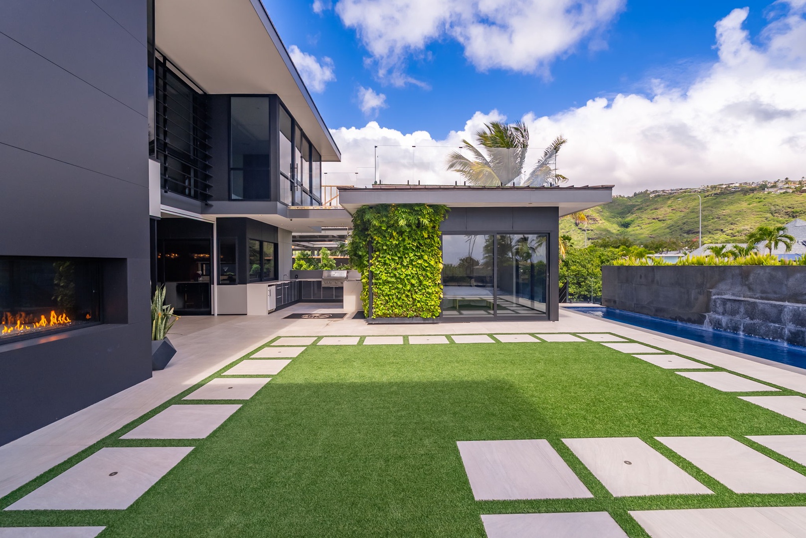 Honolulu Vacation Rentals, Ocean Villa 3 Bedroom - Modern courtyard with clean lines, green wall feature, and open-air design.