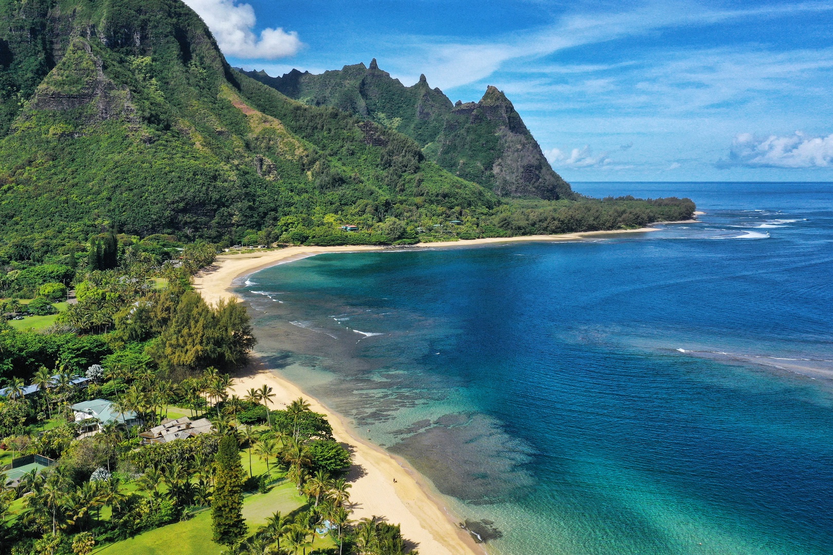 Koloa Vacation Rentals, Ke Kai Nui at Kukuiula - Aerial view of Tunnels Beach, known for its golden sands, turquoise waters, and breathtaking mountain vistas.