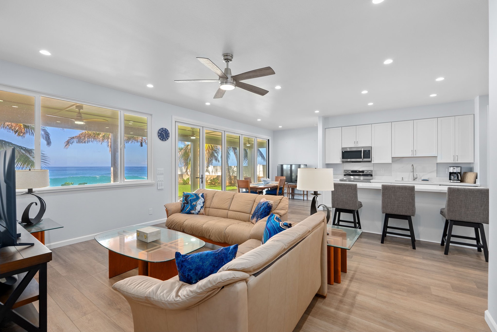 Waianae Vacation Rentals, Oceanfront Luxury Dream Estate - Lower-level living area with coastal textures, ceiling fan, and wall-to-wall ocean views.
