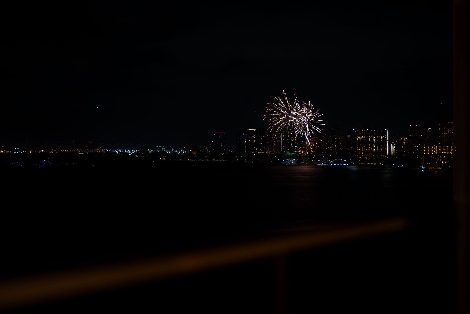 Honolulu Vacation Rentals, Hale Kaimana - Colorful bursts of fireworks creating a magical spectacle over the horizon.