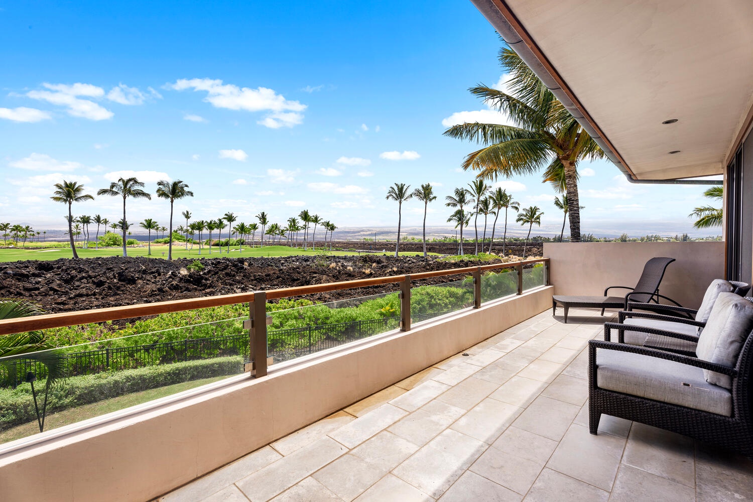 Kamuela Vacation Rentals, Laule'a at the Mauna Lani Resort #14 - Upper lanai offers peaceful seating with views of swaying palms and lava rock landscapes.