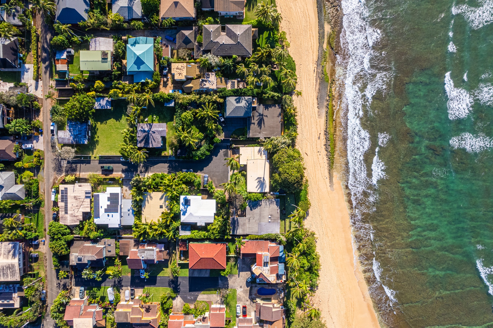 Haleiwa Vacation Rentals, Sunset Point Hawaiian Beachfront** - Aerial shot of the shores.