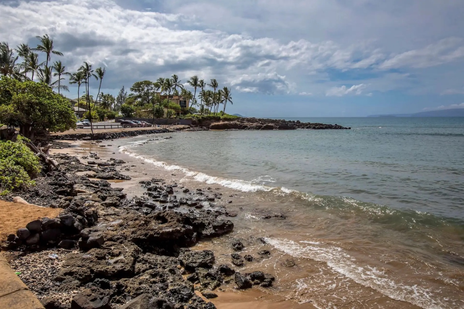 Kihei Vacation Rentals, Kalama Terrace P302 - Where the lava rock meets the water, condos rise beyond the palms at this bend in the coast.