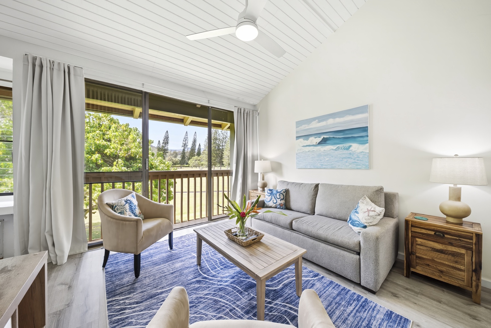 Kahuku Vacation Rentals, Kuilima Estates West #132 - Sliding doors open off the living room toward the palms, letting afternoon light pour in.