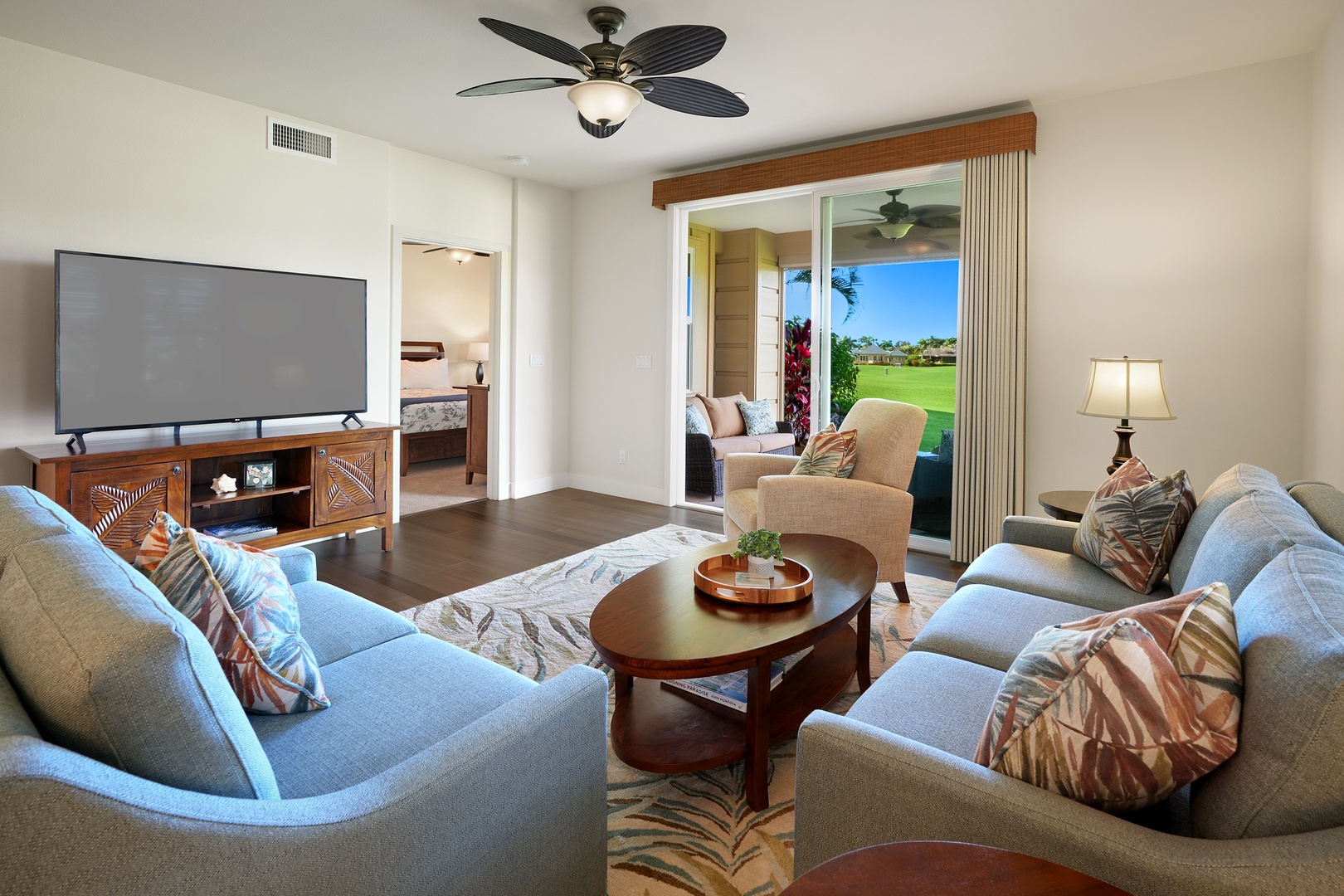 Koloa Vacation Rentals, Pili Mai 6J - Relax in your spacious living room with plush seating, entertainment center, and stunning golf course views through sliding glass doors.