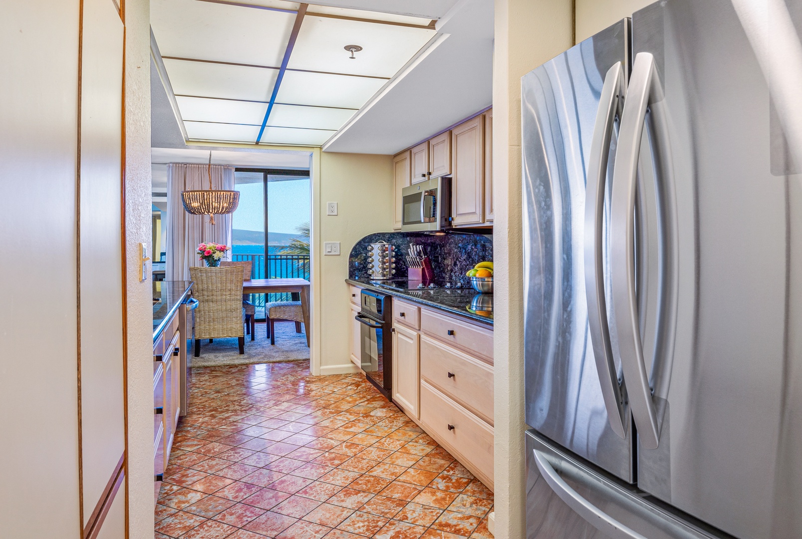 Lahaina Vacation Rentals, Kaanapali Shores 502 - walk through kitchen with modern floors and amenities.