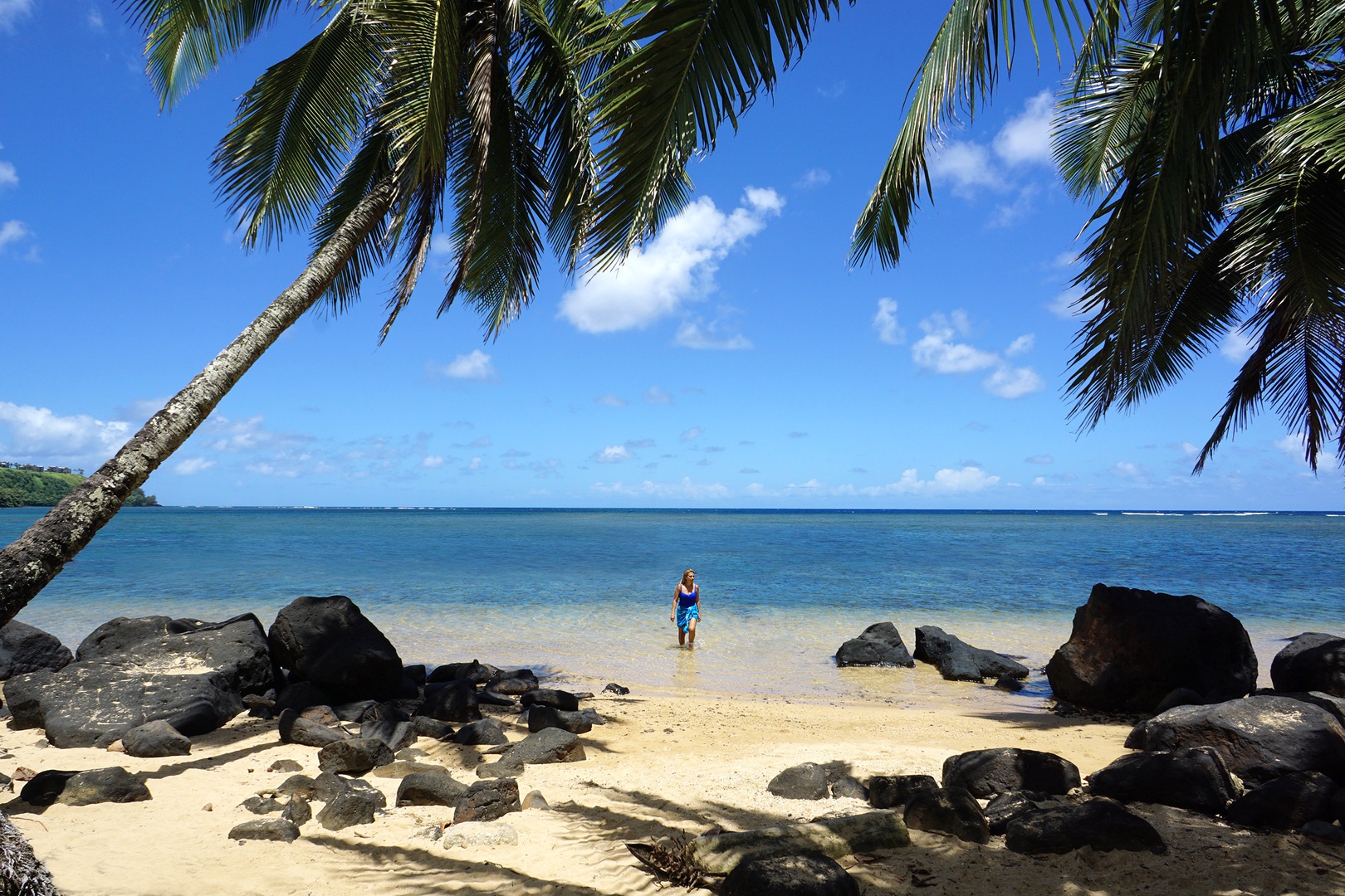 Koloa Vacation Rentals, Ke Kai Nui at Kukuiula - Wyllie’s Beach, a serene shoreline with soft sand, swaying palms, and crystal-clear water.