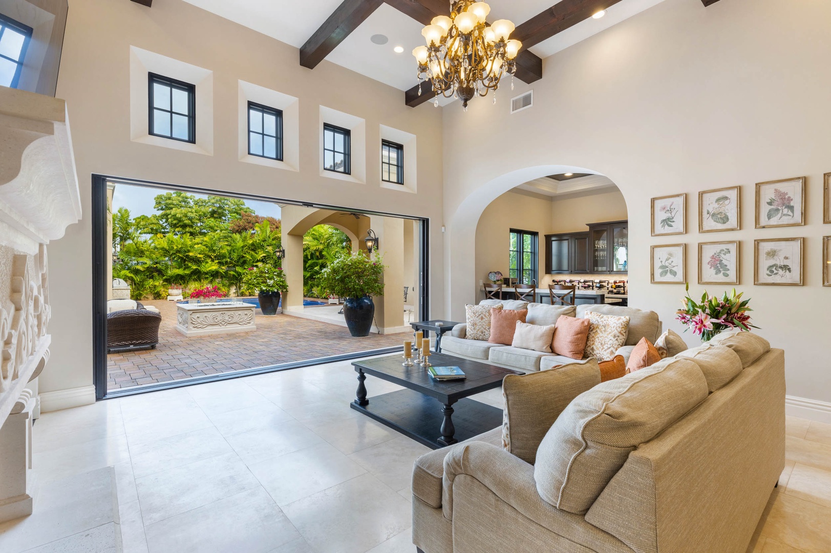 Honolulu Vacation Rentals, The Kahala Mansion Event Venue - Living room opening to an outdoor patio, seamlessly blending indoor and outdoor spaces for entertaining.