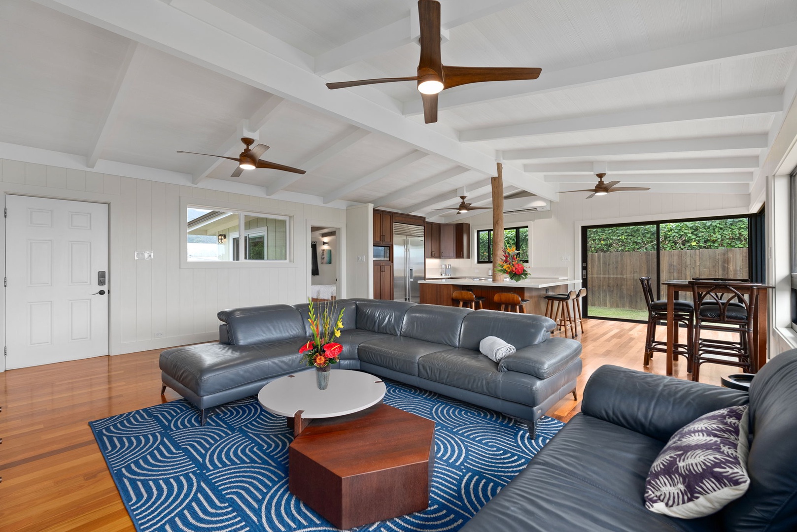 Waialua Vacation Rentals, Mokuleia Beach Villa** - Relax in the living area offering a spacious sectional, a perfect spot for unwinding or gathering.