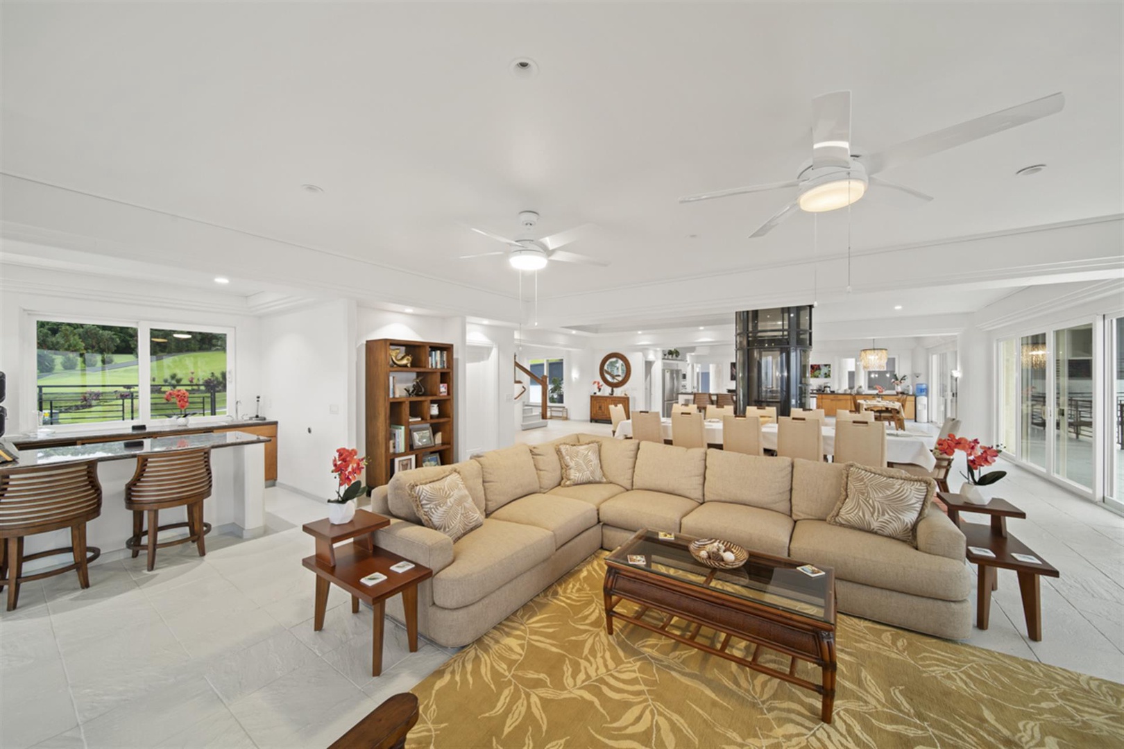 Ninole Vacation Rentals, Waterfalling Estate** - Wider view of great room toward the capacious kitchen.