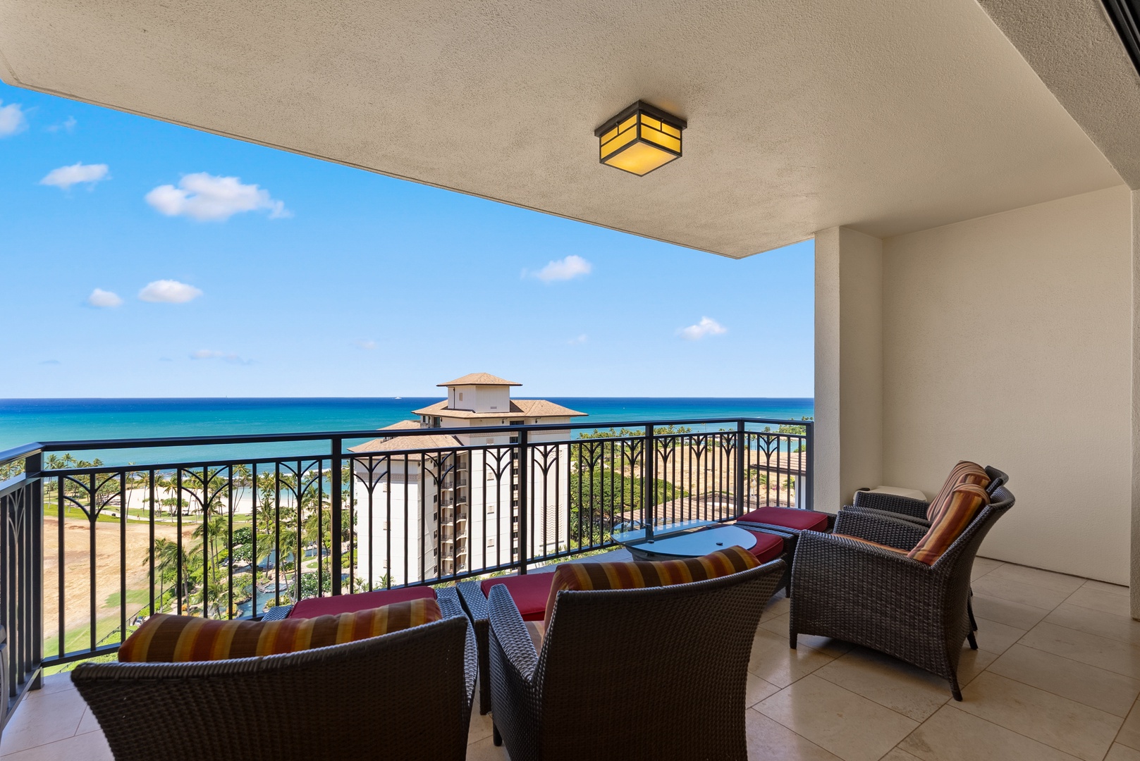 Kapolei Vacation Rentals, Ko Olina Beach Villas O1404 - Chairs turned to the water, the coastline curving off to one side.