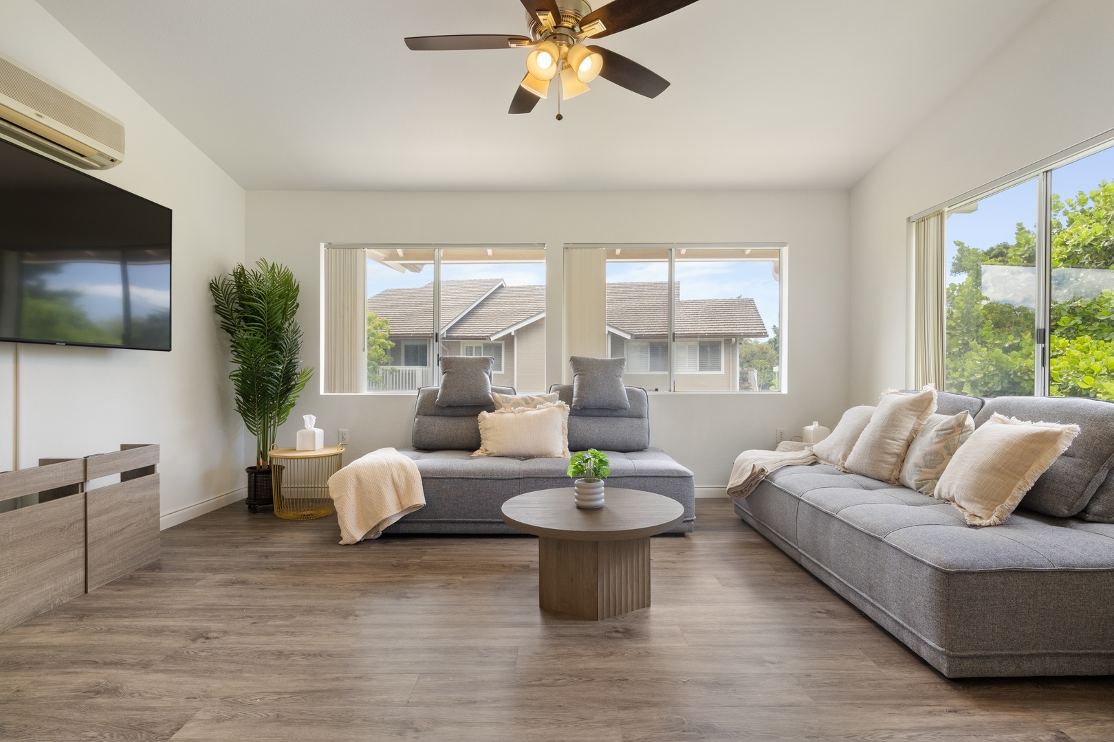 Kapolei Vacation Rentals, Fairways at Ko Olina 7A - Relax in your modern living room with plush sectional seating, ceiling fan, and natural light streaming through large windows.