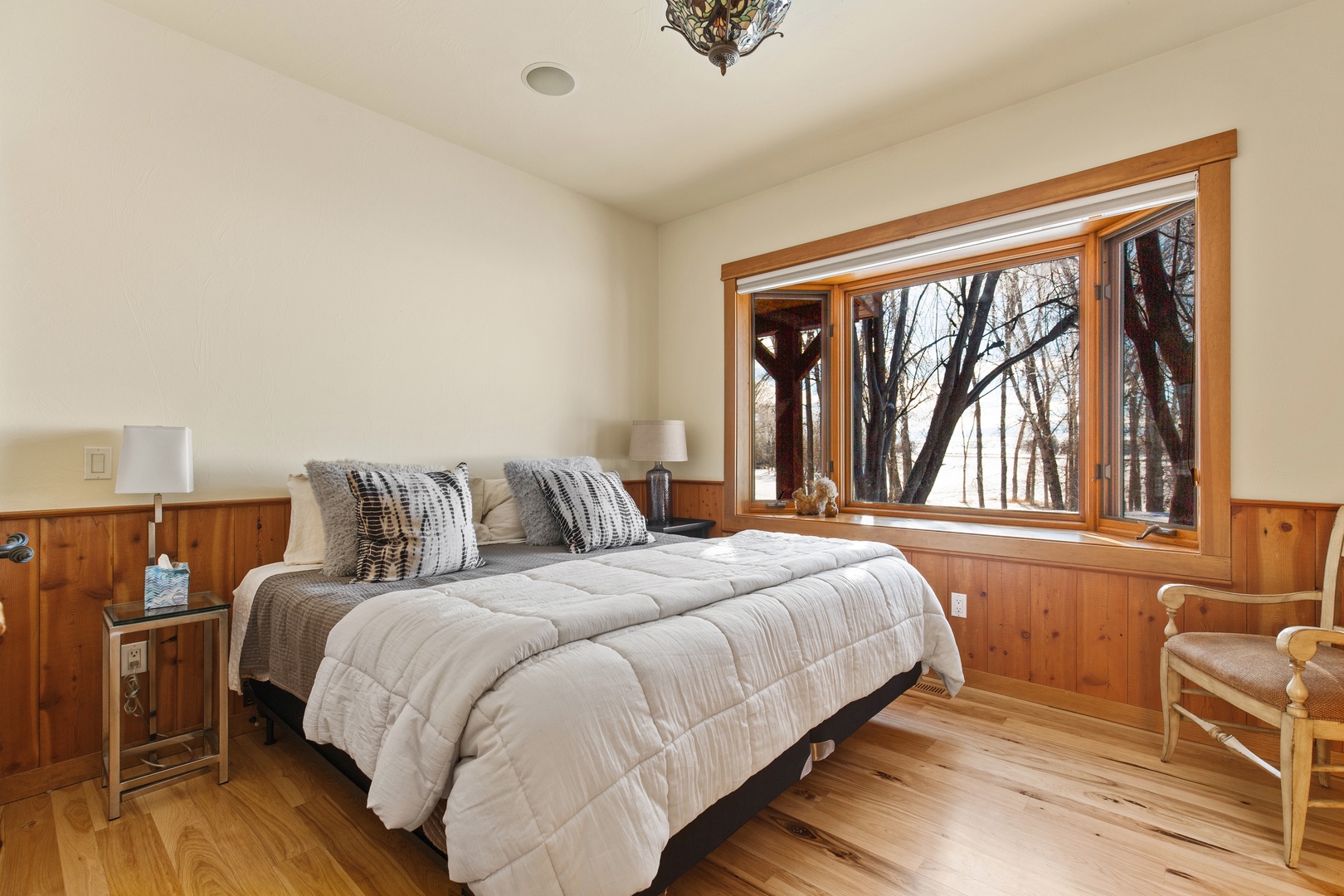 Bozeman Vacation Rentals, The Woodland Oasis - Primary bedroom with king bed and view to the woods