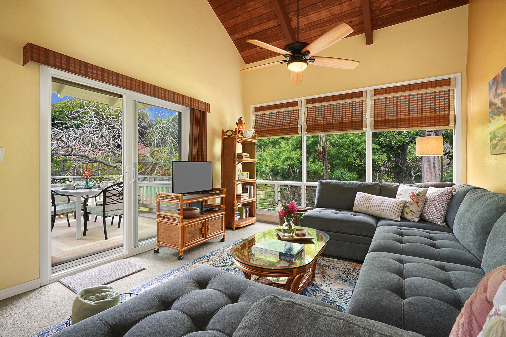Koloa Vacation Rentals, Kauai Birdsong at Poipu Crater - The cozy living area has a plush sectional sofa, TV and large glass window walls and sliders for a bright and airy ambiance.