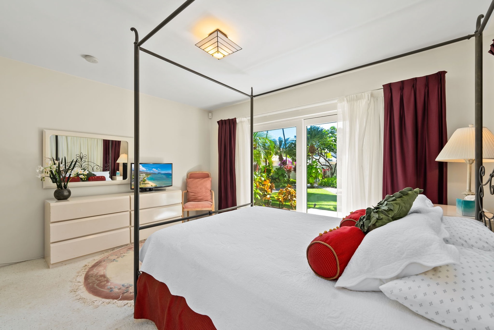 Honolulu Vacation Rentals, Kahala Oasis - Elegant guest suite with a four-poster king bed and large window overlooking the garden for a serene retreat.