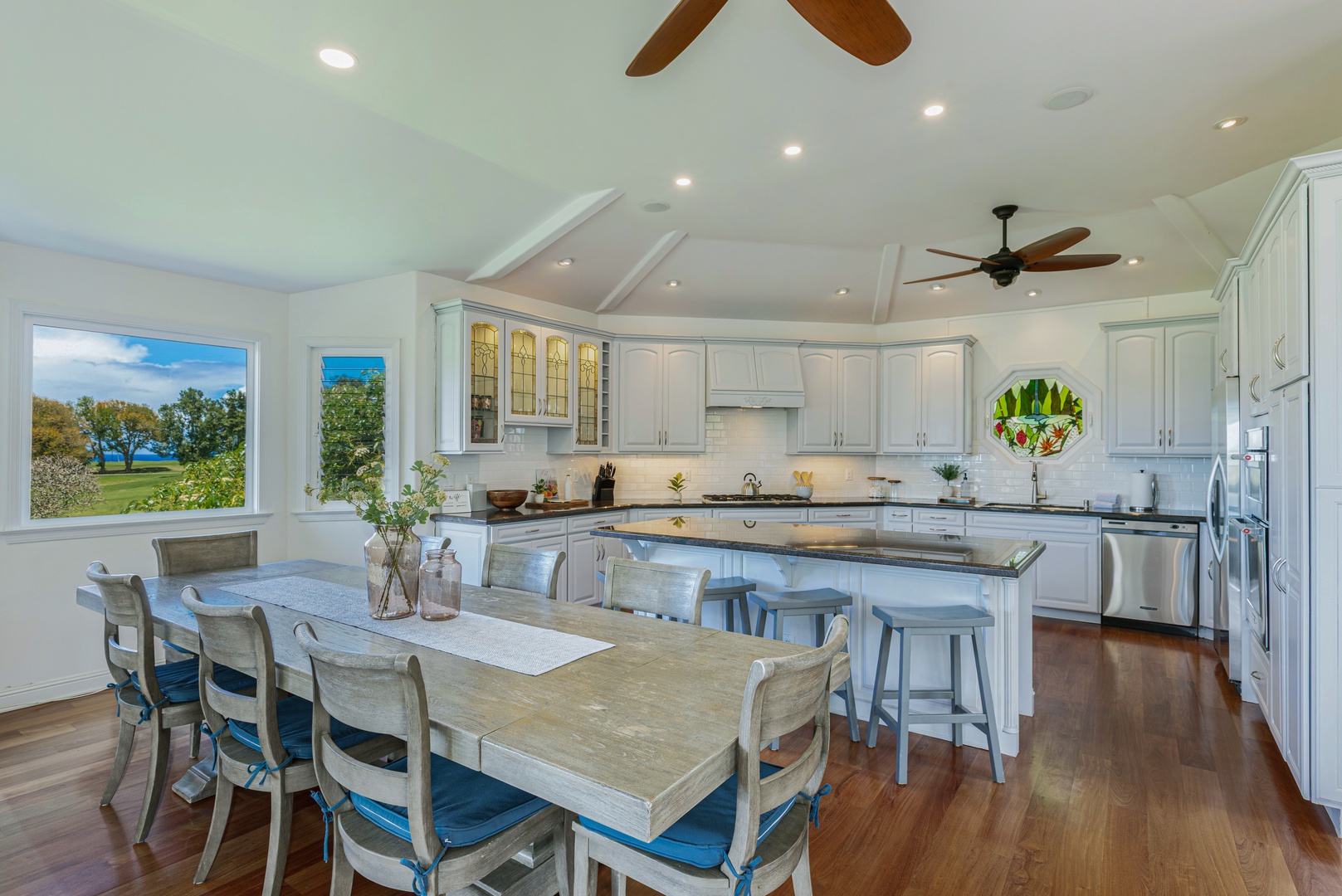 Princeville Vacation Rentals, Ohana Kamalani - Gourmet kitchen featuring a large island with bar seating, high-end appliances, and generous counter space for effortless cooking.