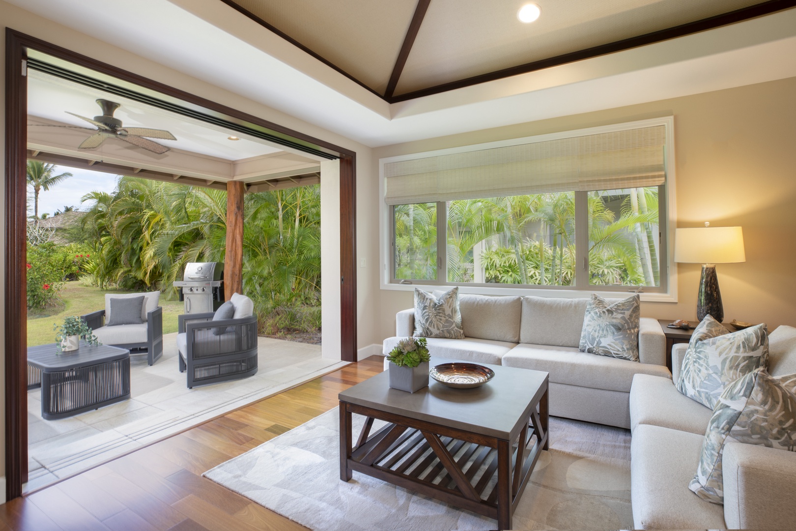 Kamuela Vacation Rentals, Mauna Lani KaMilo #503 - Settle into the elegant indoor lounge with large windows that bring natural light and greenery inside.