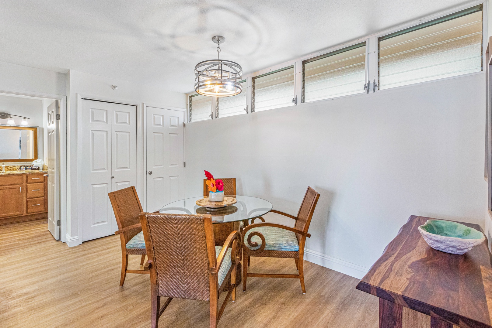 Lahaina Vacation Rentals, Royal Kahana 213 - A cozy dining area with seating for four, perfect for enjoying meals together in a relaxed setting.