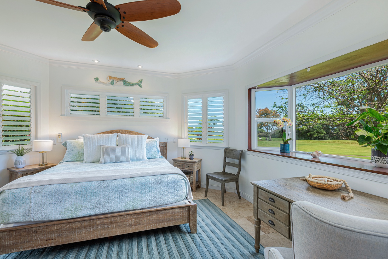 Princeville Vacation Rentals, Ohana Kamalani - Bright and airy primary bedroom with corner windows and a coastal-inspired design for a restful night's sleep.