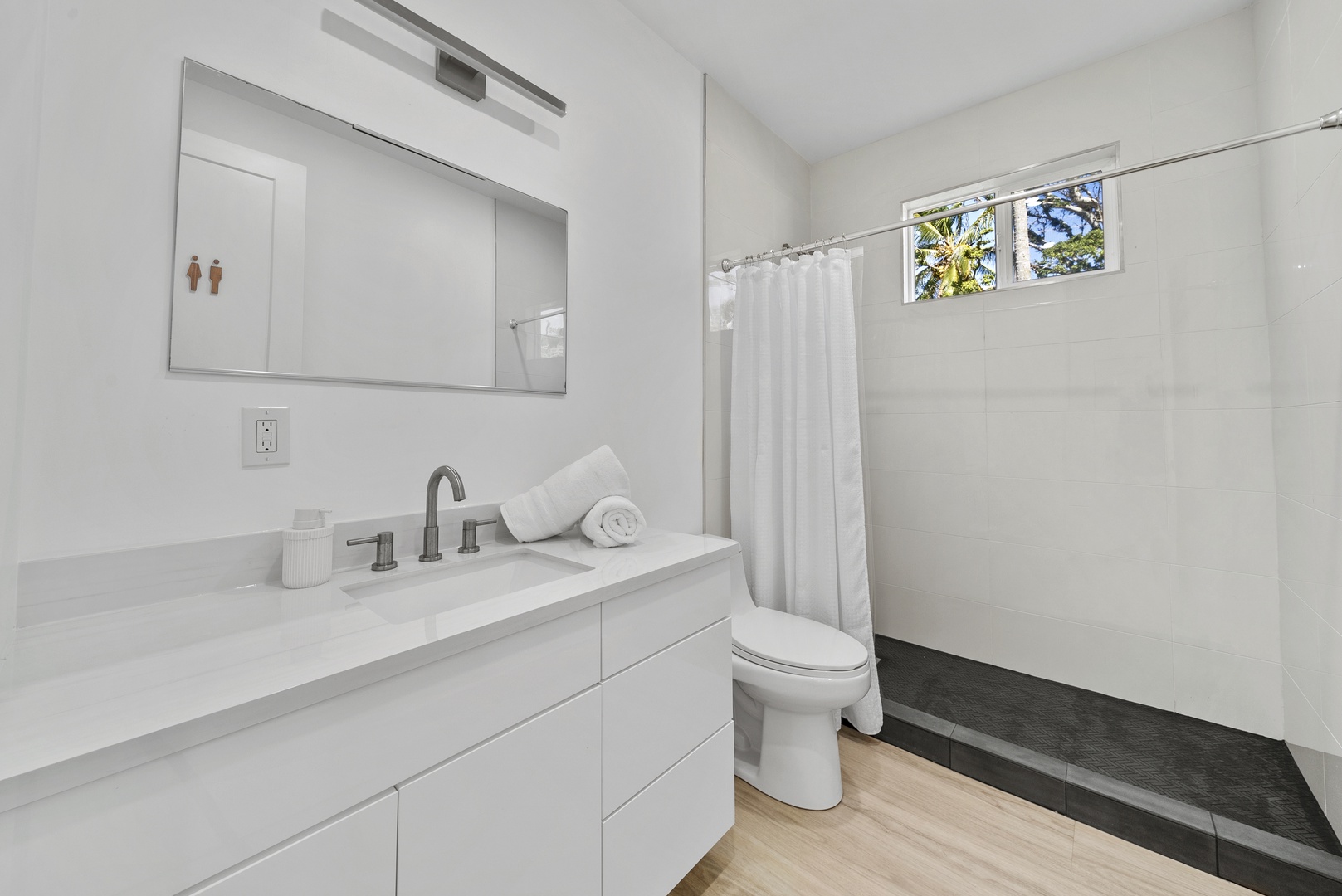 Haleiwa Vacation Rentals, Sunset Beach Island Retreat - Downstairs bathroom features a spacious walk-in shower with a sleek, modern vanity