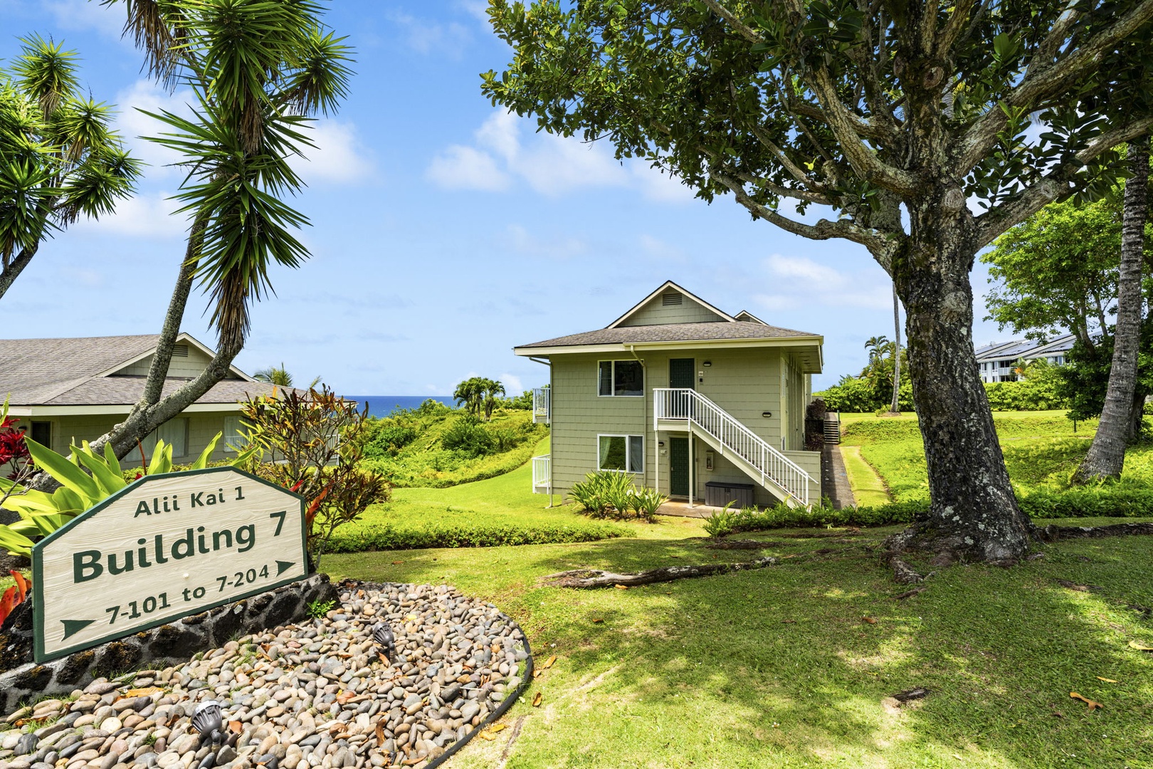 Princeville Vacation Rentals, Alii Kai 7201 - Building 7 tucked into the palms and manicured lawns of the community.