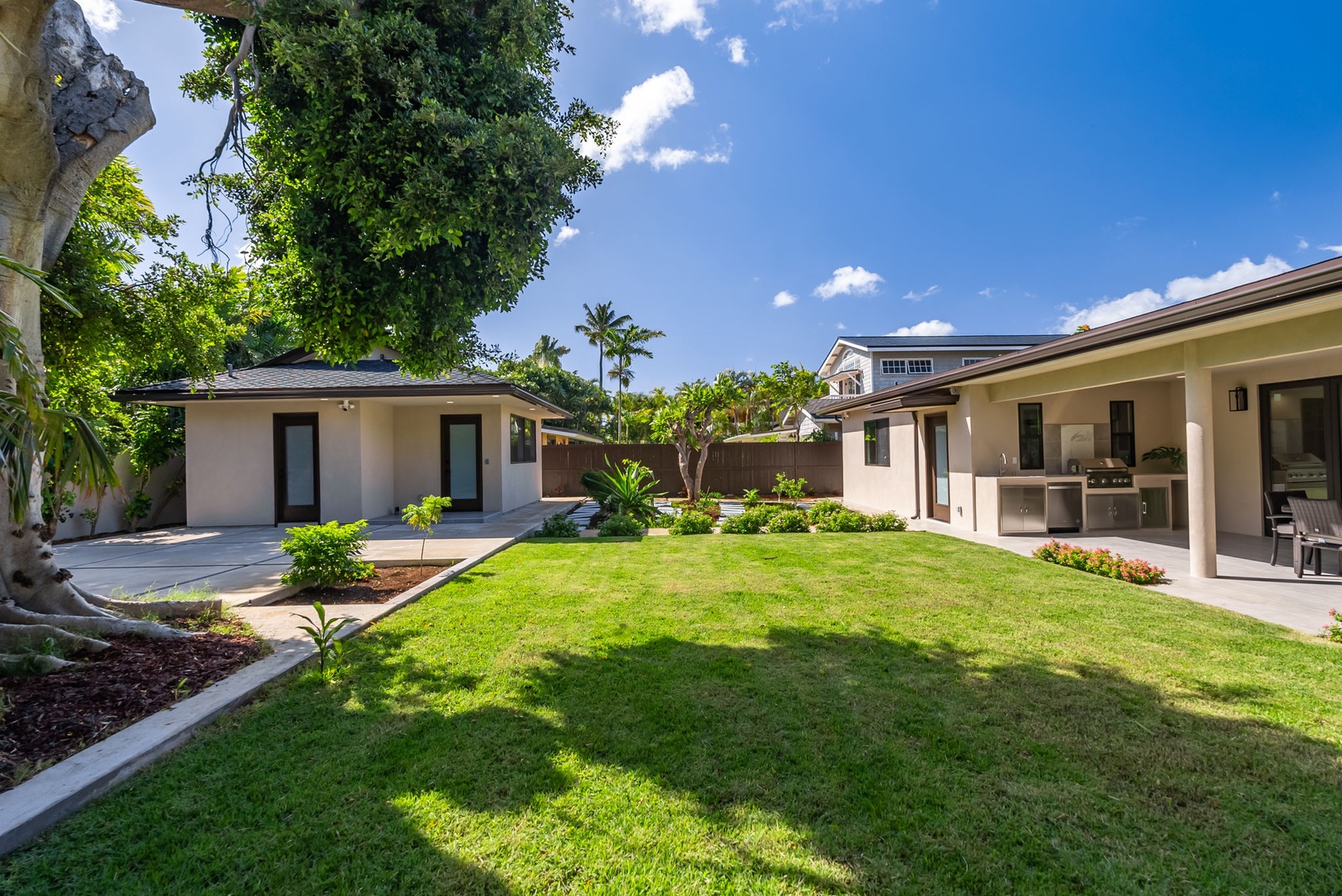 Honolulu Vacation Rentals, Kahala Zen - Large backyard with landscaped greenery, ideal for family gatherings.