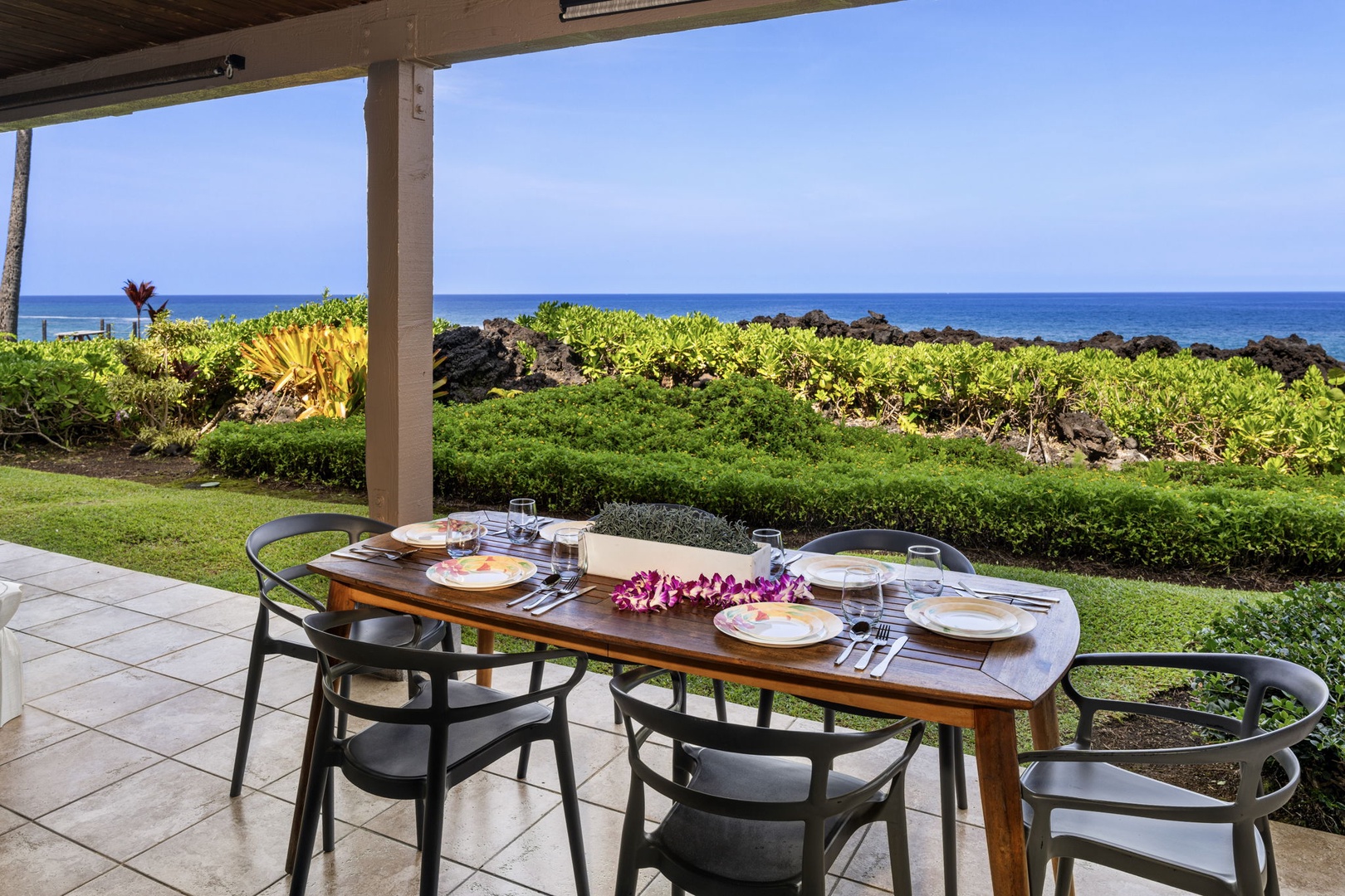 Kailua Kona Vacation Rentals, Keauhou Kona Surf & Racquet 1104 - Set the table outside where the lawn runs to the water for dinner in the open air.