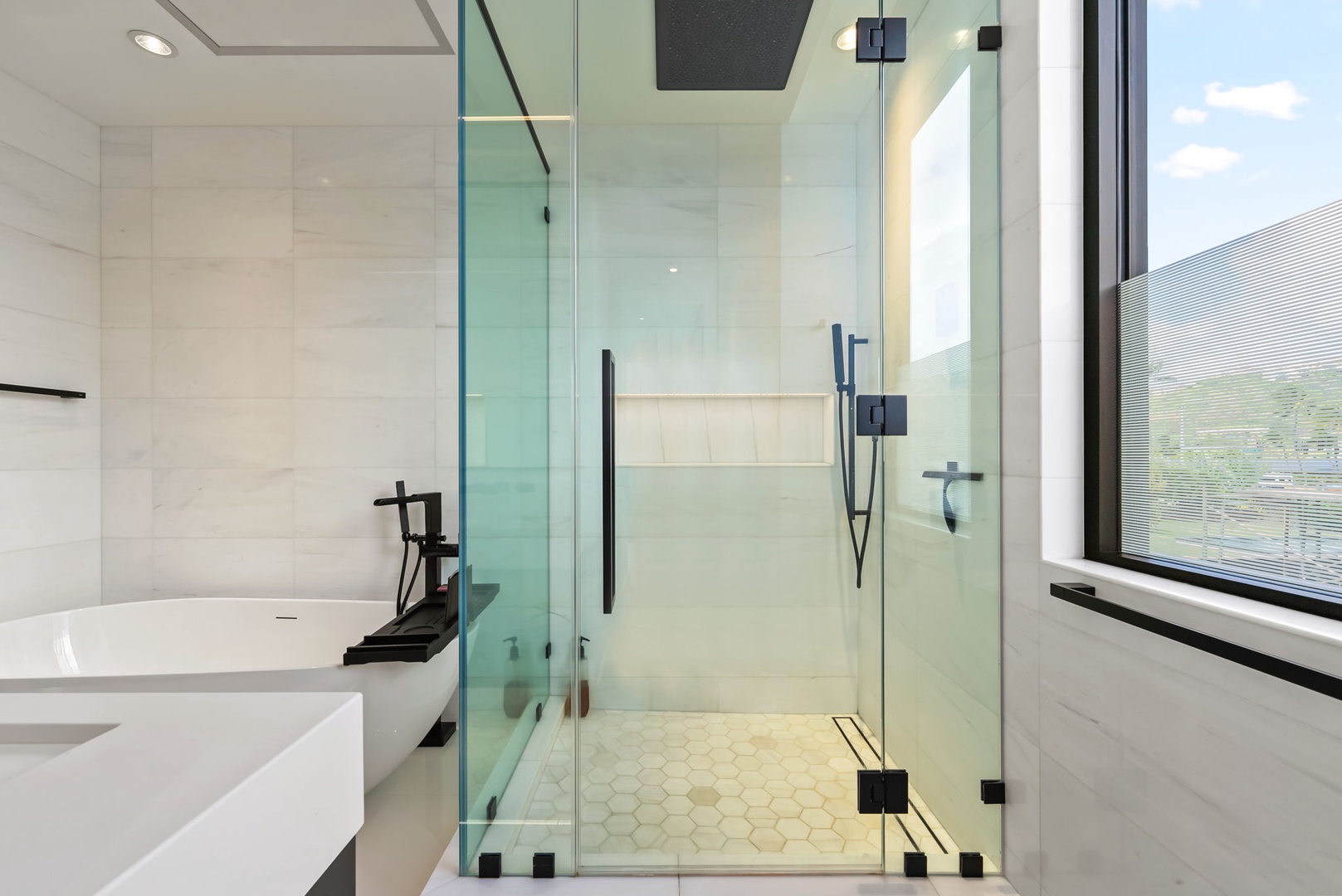 Honolulu Vacation Rentals, Ocean Villa Emilie - A sleek walk-in shower with a rainfall head and frameless glass enclosure offers a spa-like refresh after ocean adventures.