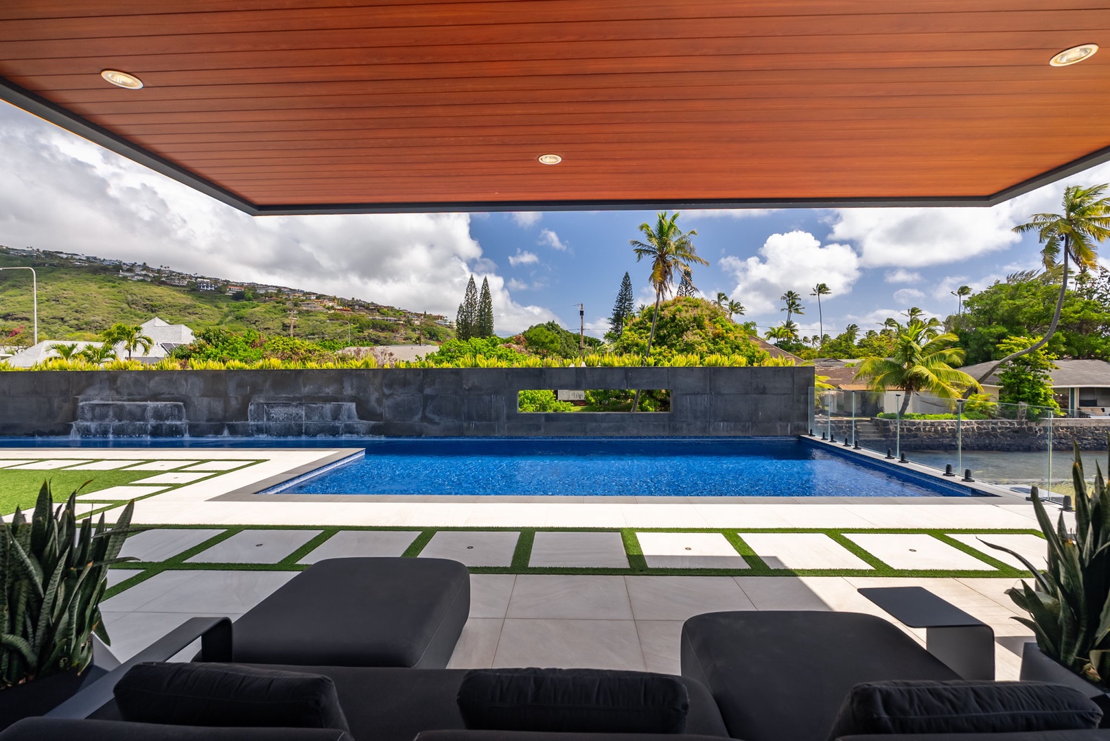 Honolulu Vacation Rentals, Ocean Villa Emilie - Elevated outdoor living with lap pool views framed by the villa’s architectural canopy.