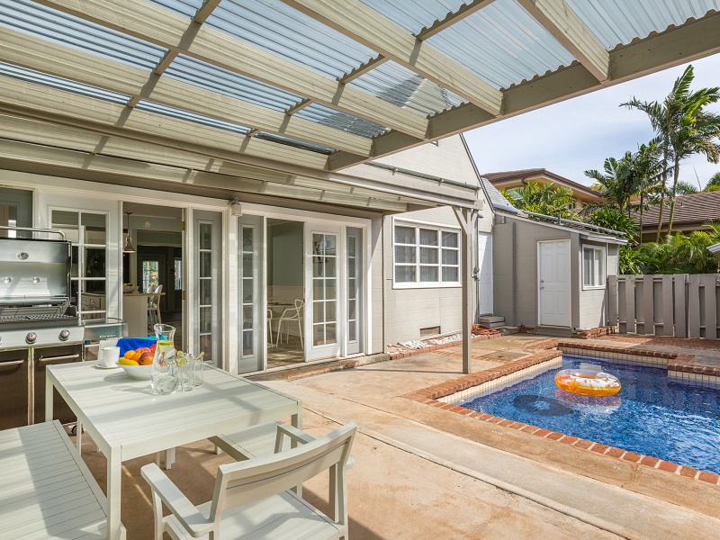 Honolulu Vacation Rentals, Ho'okipa Villa - Host a backyard barbecue in this covered outdoor lanai by the pool.