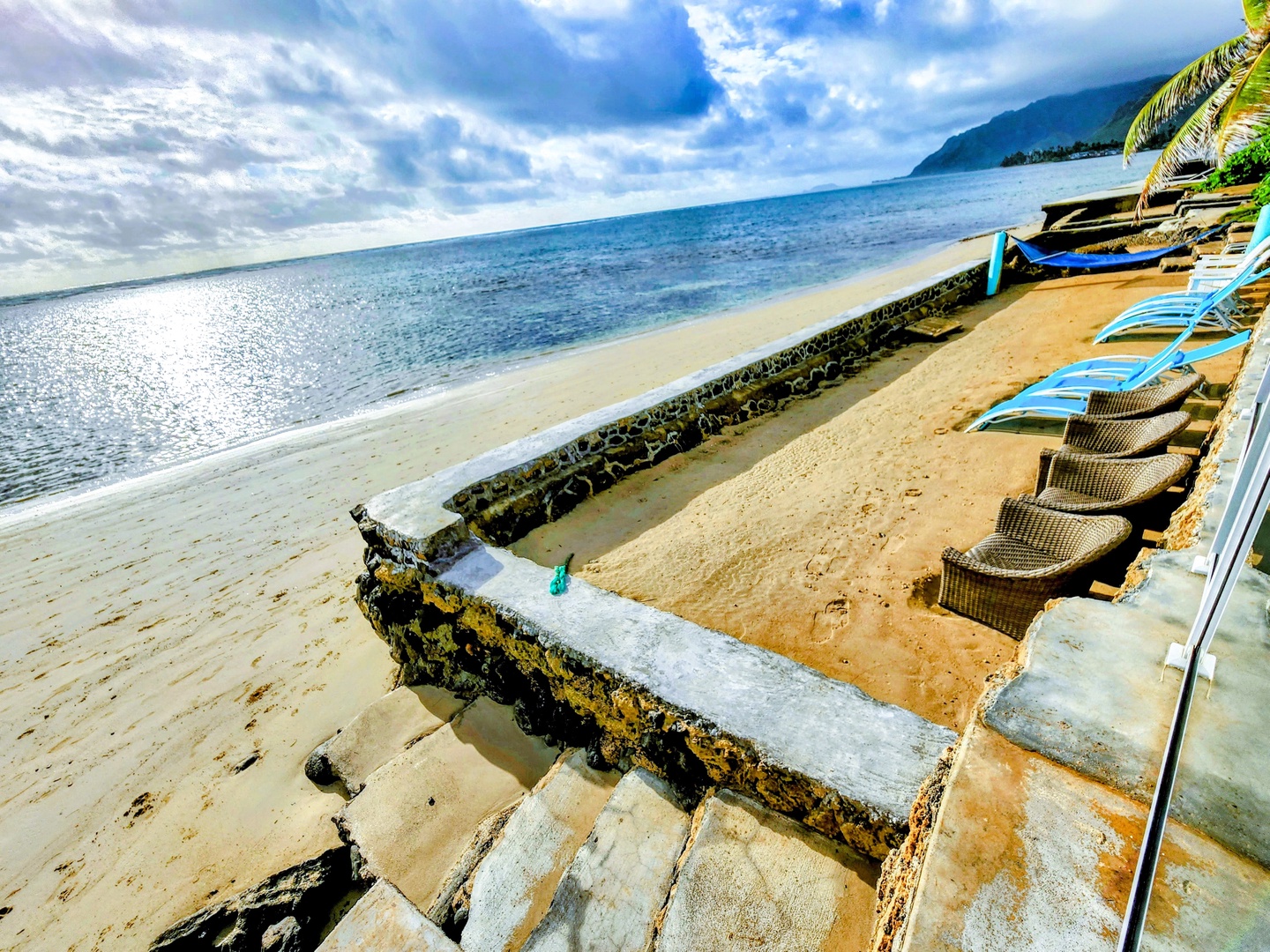 Hauula Vacation Rentals, Private Beach Paradise - Loungers line the seawall above a reef shoreline made for slow snorkeling.