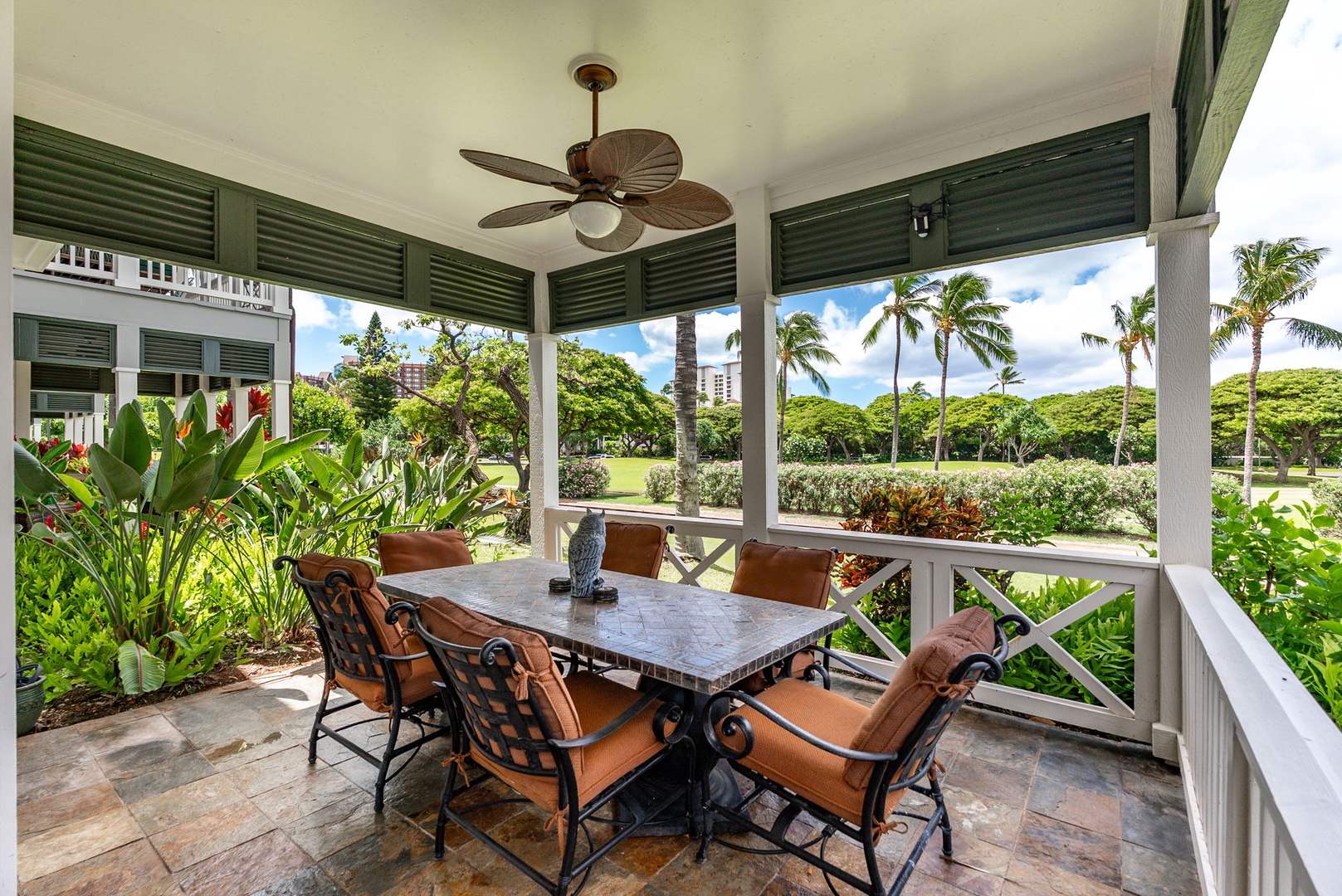 Kapolei Vacation Rentals, Coconut Plantation 1080-4 - Long lanai table where dinner stretches out into the evening under cover.