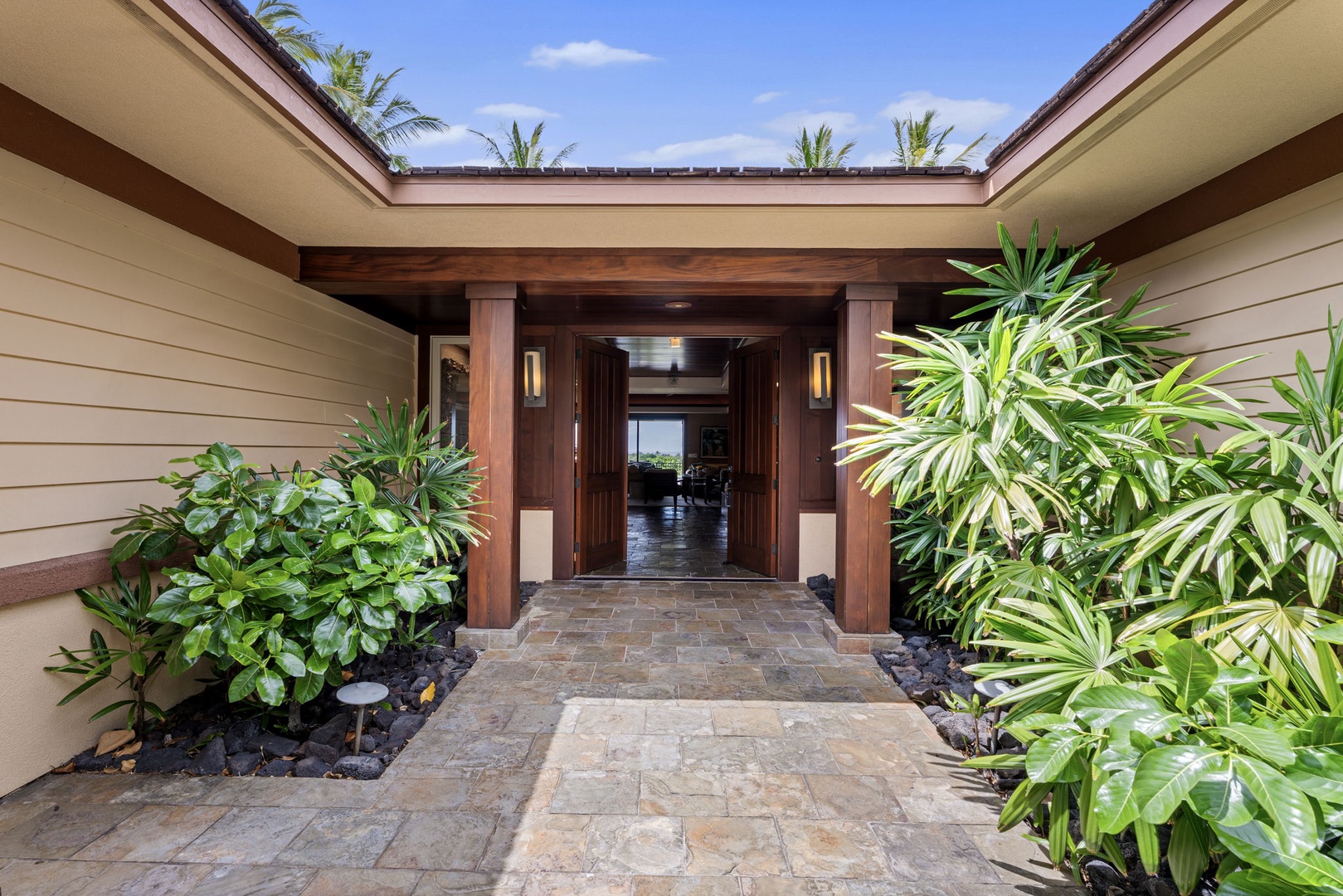 Kailua Kona Vacation Rentals, 3BD Pakui Street Estate (149) at Hualalai Resort - Open to the sky, a stone path threads between koa posts and tropical planting.