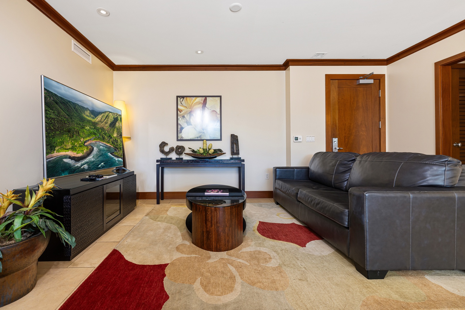 Sink into the plush leather sofa and enjoy your favorite shows on the large flat-screen TV in this inviting living space designed for ultimate relaxation.