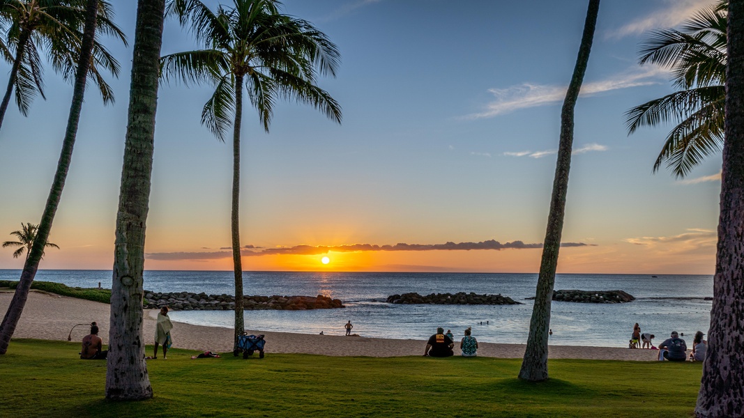 Kapolei Vacation Rentals, Fairways at Ko Olina 7A - Tropical beach setting with golden sunset, swaying palm trees, and pristine shoreline creates the perfect Hawaiian escape backdrop.