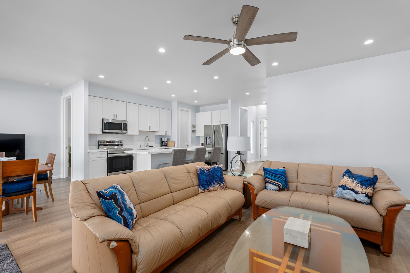 Waianae Vacation Rentals, Oceanfront Luxury Dream Estate - Chic lower-level living area with plush sectional sofas, open layout, and easy indoor-outdoor access.