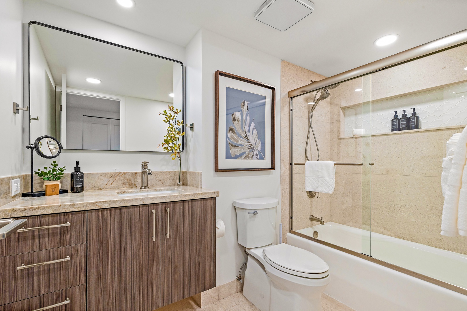 Lahaina Vacation Rentals, Kaanapali Shores 702 - The bathroom offers a modern design with a sleek vanity, glass-enclosed shower, and soft lighting for a refreshing start to your day.