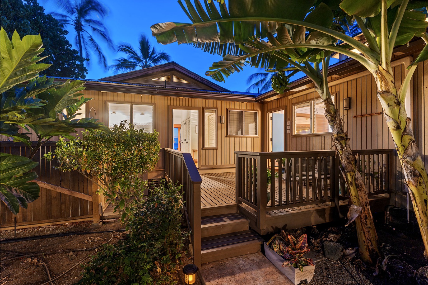 Kamuela Vacation Rentals, Island Time Retreat - One of the home's separate structures, lit up against the evening green.