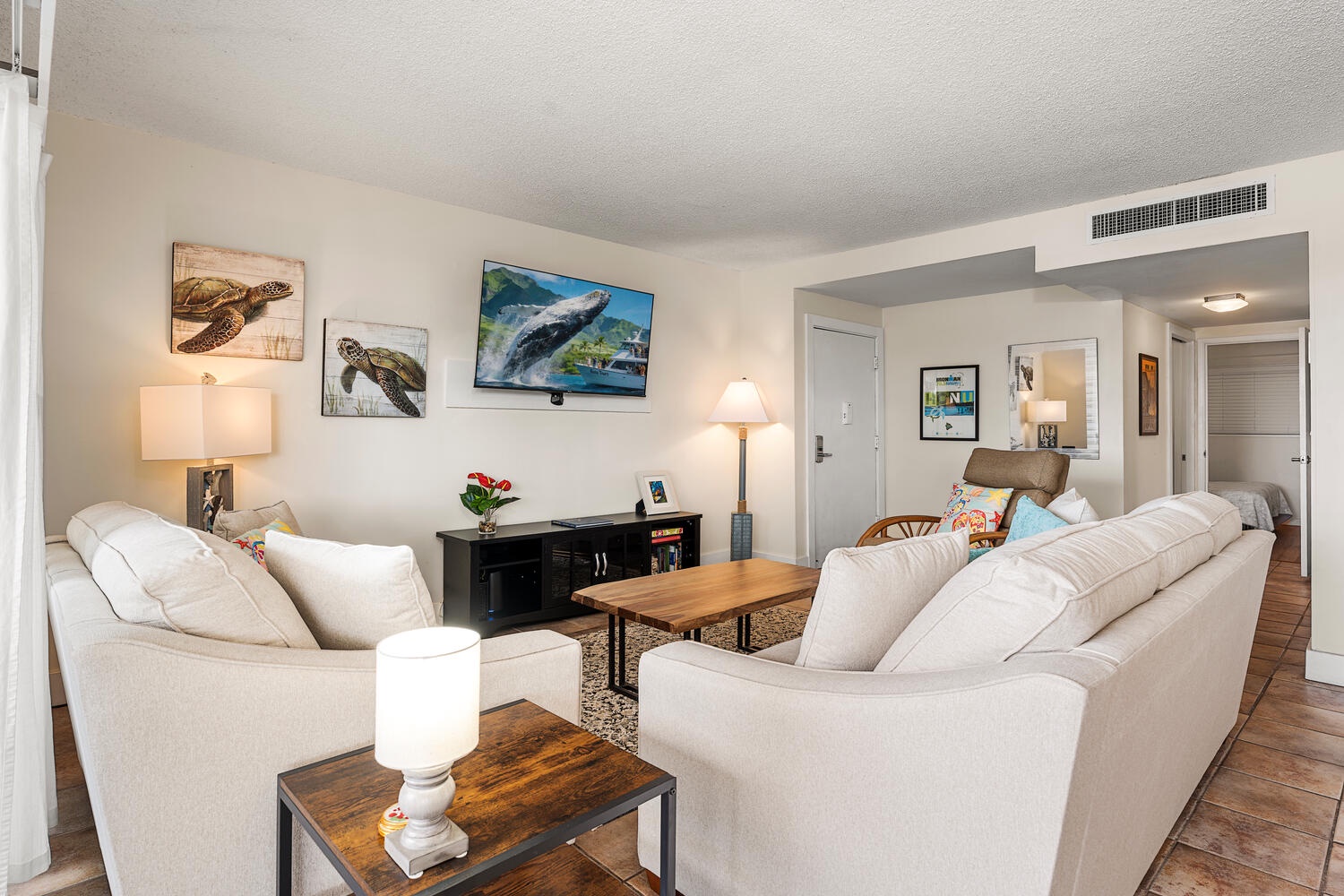 Kailua Kona Vacation Rentals, Kona Plaza 201 - Sink into plush sofas while ocean-inspired art surrounds you in this bright, welcoming space perfect for relaxing together.